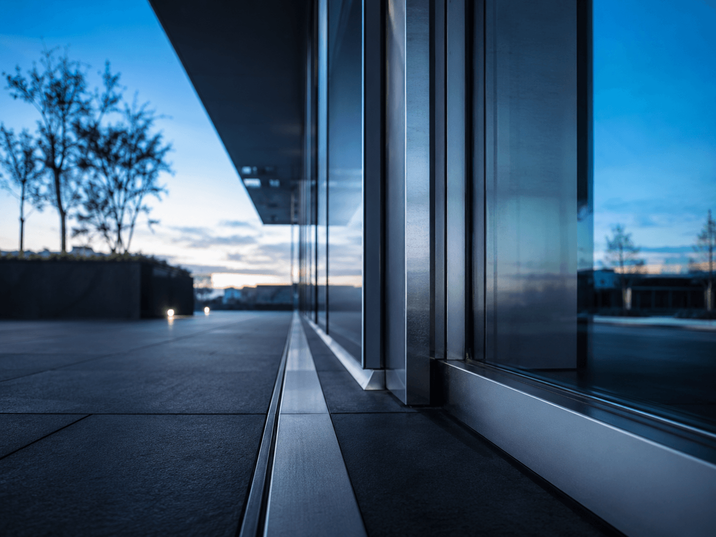 Glass facade of an office building at dusk